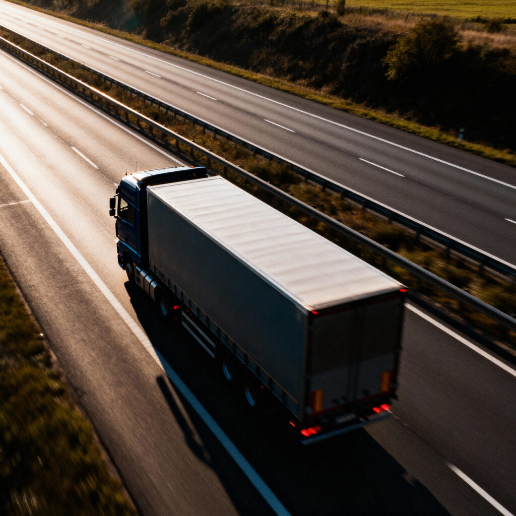 long haul semi trailer truck driving multi lane highway sunset